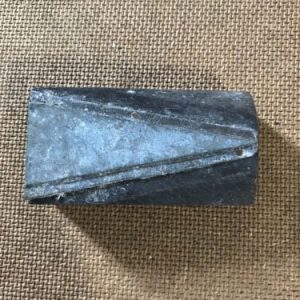 Vintage Metal Triangle On Wooden Printer Block